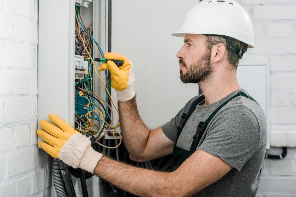 Licensed electrician servicing an electrical panel